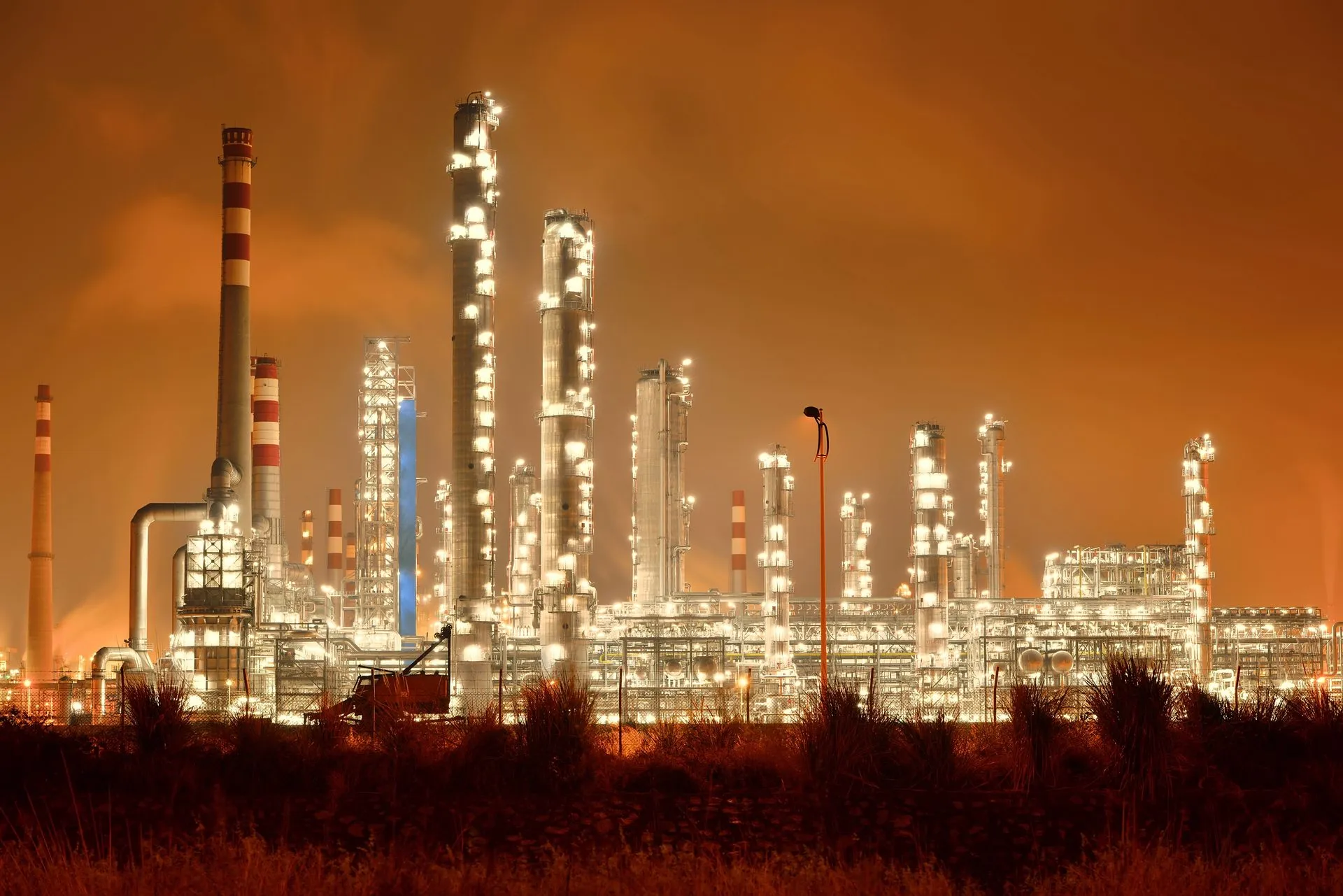 Industrial refinery plant at night — Indusroof serves oil & gas, power, and infrastructure sectors